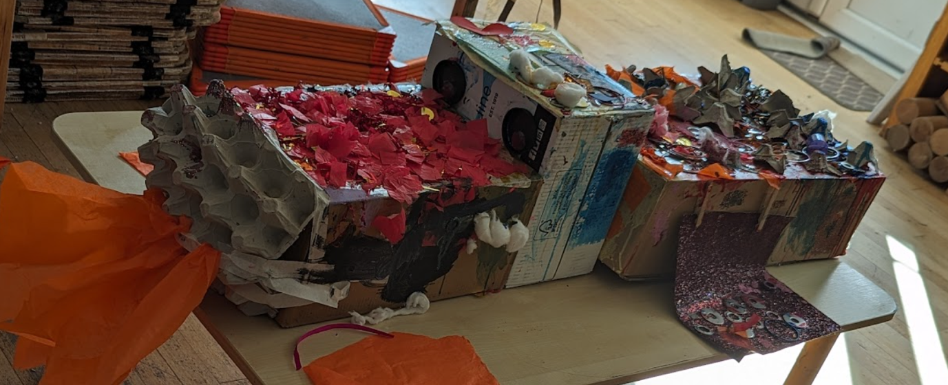 A box with torn pieces of paper on top of it
Description automatically generated